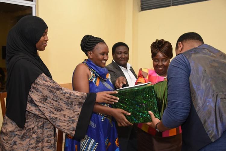 Dr Adelaide Mbithi receives gift from the staff at he Exams Centre End of Year Party 2019