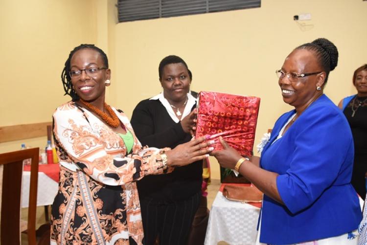 Mrs Jennifer Odhiambo receives gifts from staff at the Exam Centre end-of-year party 2019