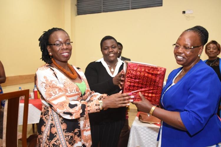 Mrs Jennifer Odhiambo receives gifts from staff at the Exam Centre end-of-year party 2019