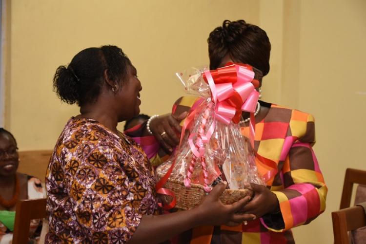 Dr Adelaide Mbithi receives gifts from Ms Dianrose Ivati during end-of-year 2019 staff party for the Examinations