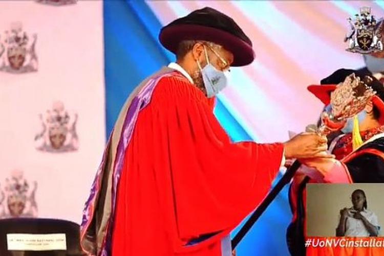 Prof. Kiama receives the university mace during the formal installation ceremony.