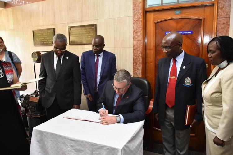 Prof. Ogeng'o (Second from the right) looks on as President of the Washington State, Kirk Schulz, University signs the visitors book at the Faculty of Engineering during his visit on 6th February, 2023
