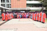 PhD Graduates pause for a photo with University administration
